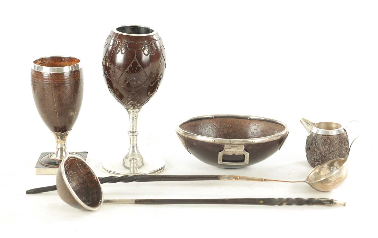 Lot 802 - TWO LATE GEORGIAN SILVER MOUNTED COCONUT GOBLETS