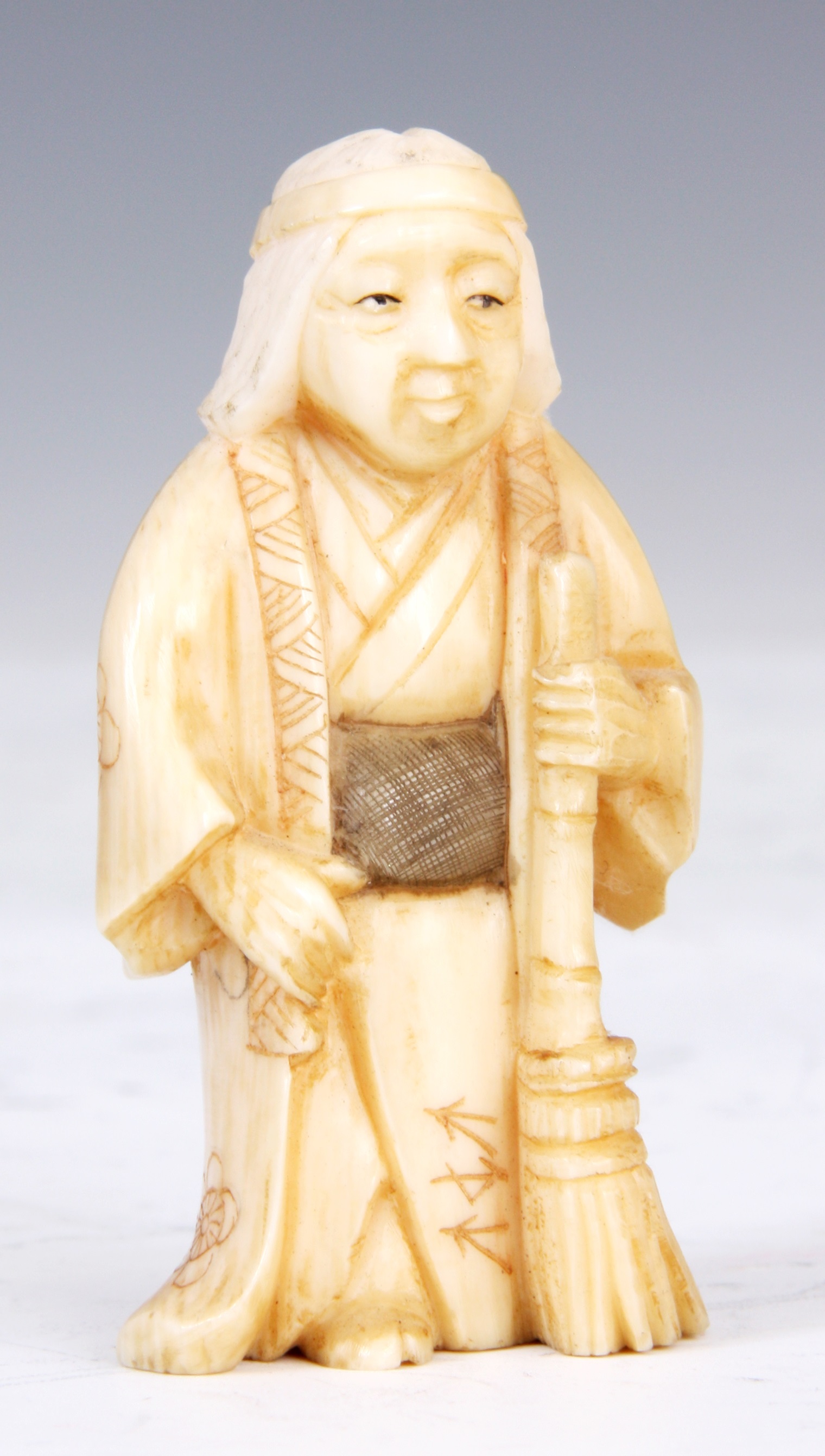 Lot 106 - A JAPANESE IVORY SCULPTURE of an oriental