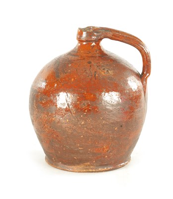 Lot 76 - AN EARLY BROWN GLAZED TERRACOTTA WINE JAR