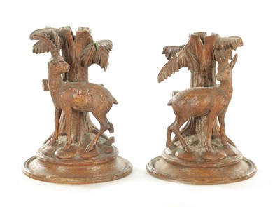 Lot 1173 - A PAIR OF LATE 19TH CENTURY CARVED BLACK FOREST CANDLESTICKS