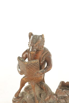 Lot 1158 - A LATE 19TH CENTURY CARVED BLACK FOREST DESK FOX TIDY