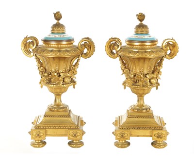 Lot 706 - A PAIR OF 19TH CENTURY FRENCH GILT ORMOLU AND SERVES LIDDED URNS