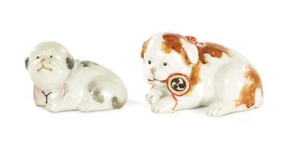 Lot 227 - TWO JAPANESE MEIJI PERIOD PORCELAIN FIGURES OF RECUMBENT DOGS