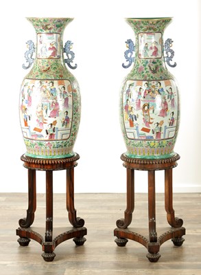 Lot 120 - AN IMPRESSIVE PAIR OF 19TH CENTURY CANTONESE CELADON GROUND AND FAMILLE ROSE HALL VASES ON LATE REGENCY ROSEWOOD STANDS