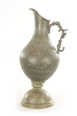 Lot 224 - A 19TH CENTURY INDIAN PROFUSELY ENGRAVED AND EMBOSSED GIANT EWER