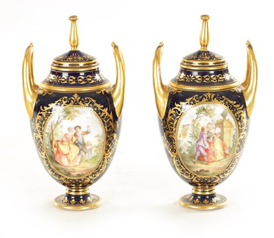 Lot 59 - A PAIR OF 19TH CENTURY VIENNA PORCELAIN RICHLY GILT AND ROYAL BLUE TWO HANDLED COVERED VASES