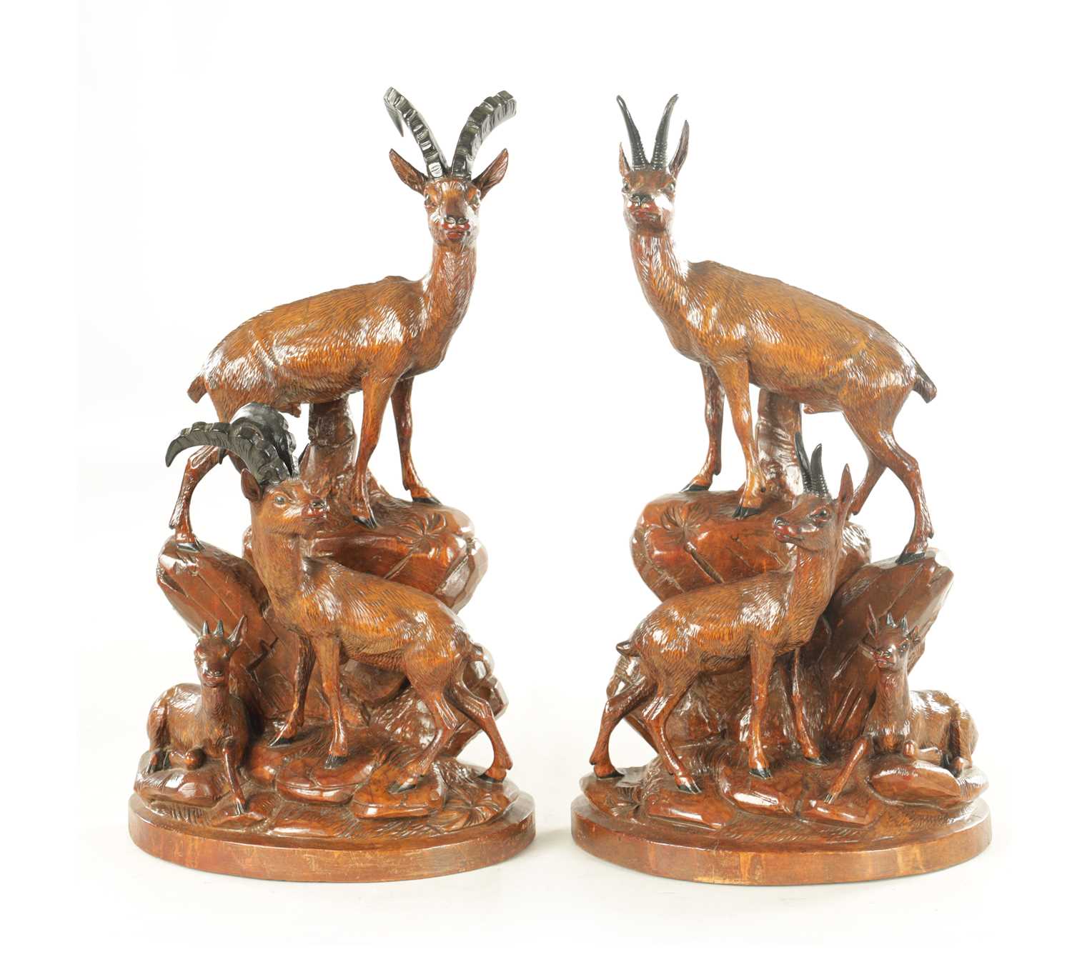 Lot 1194 - A PAIR OF 19TH CENTURY BLACK FOREST CARVED LINDEN WOOD SCULPTURES