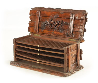 Lot 1207 - A 19TH CENTURY BLACK FOREST CARVED LINDEN WOOD HUMIDOR