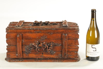 Lot 1207 - A 19TH CENTURY BLACK FOREST CARVED LINDEN WOOD HUMIDOR