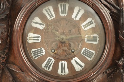 Lot 1105 - A 19TH CENTURY BLACK FOREST CARVED OAK HANGING WALL CLOCK