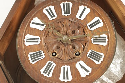 Lot 1105 - A 19TH CENTURY BLACK FOREST CARVED OAK HANGING WALL CLOCK