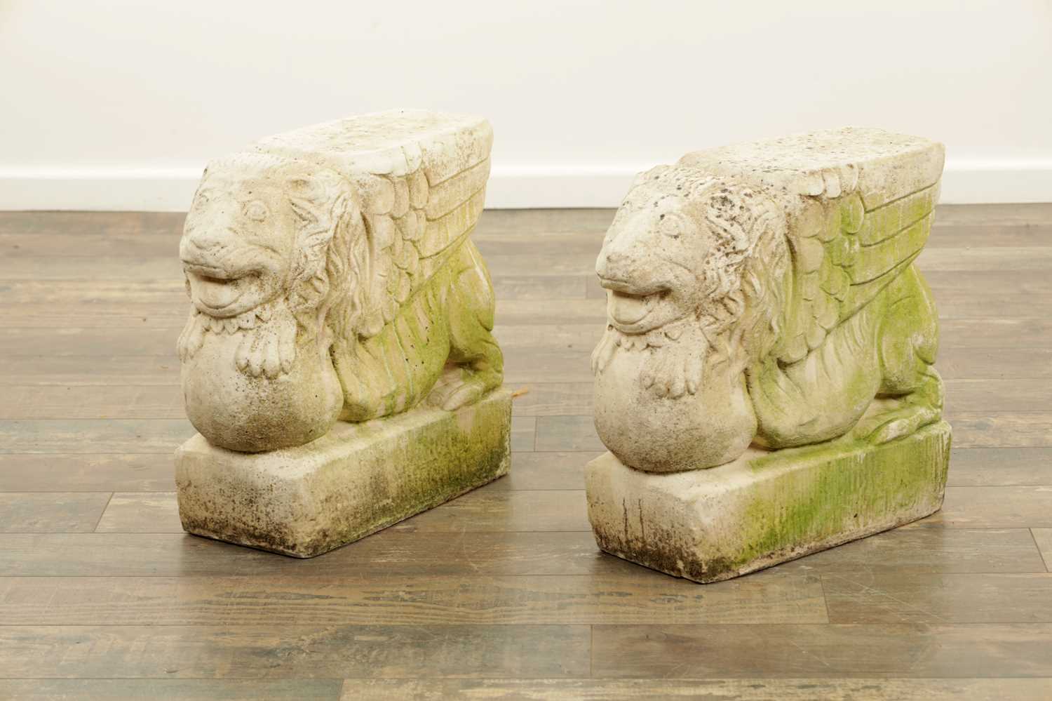 Lot 840 - A PAIR OF CARVED LIMESTONE WINGED LIONS