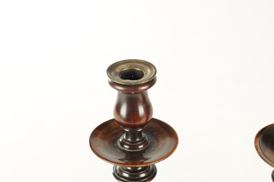 Lot 899 - A PAIR OF GEORGE III TURNED MAHOGANY CANDLESTICKS