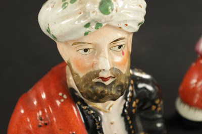 Lot 63 - A PAIR OF 19TH CENTURY FIGURAL STAFFORDSHIRE VASES