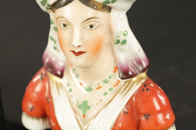 Lot 63 - A PAIR OF 19TH CENTURY FIGURAL STAFFORDSHIRE VASES