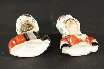 Lot 63 - A PAIR OF 19TH CENTURY FIGURAL STAFFORDSHIRE VASES