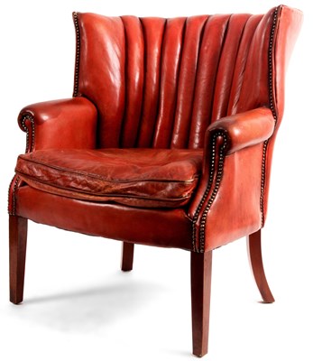 Lot 767 - A Red Leather BARREL BACK CHAIR with studded...