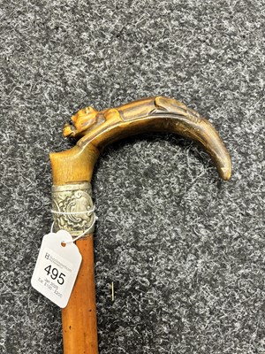 Lot 495 - A 19TH CENTURY MALACCA CANE WALKING STICK WITH CARVED RHINO HORN HANDLE