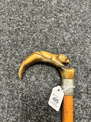 Lot 495 - A 19TH CENTURY MALACCA CANE WALKING STICK WITH CARVED RHINO HORN HANDLE