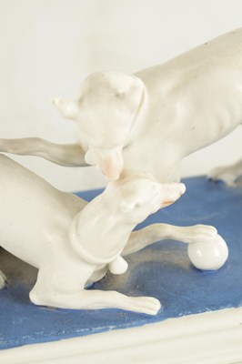 Lot 71 - A LATE 19TH CENTURY GERMAN BISQUE PORCELAIN SCULPTURE OF TWO WHIPPETS PLAYING