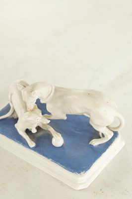Lot 71 - A LATE 19TH CENTURY GERMAN BISQUE PORCELAIN SCULPTURE OF TWO WHIPPETS PLAYING