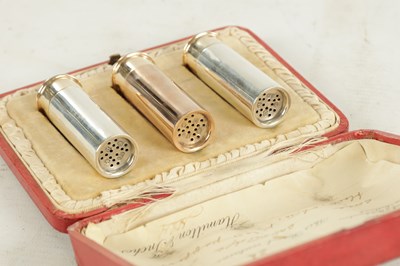 Lot 426 - AN EARLY 20TH CENTURY THREE SILVER 'SHOTGUN' CARTRIDGE PEPPER SHAKERS