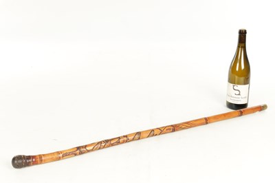 Lot 515 - AN EARLY 20TH CENTURY JAPANESE CARVED BAMBOO CARVED STICK WITH FITTED TELESCOPIC FISHING ROD