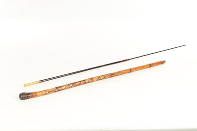 Lot 515 - AN EARLY 20TH CENTURY JAPANESE CARVED BAMBOO CARVED STICK WITH FITTED TELESCOPIC FISHING ROD