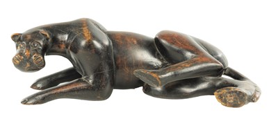 Lot 894 - A 19TH/EARLY 20TH CENTURY CARVED STAINED HARDWOOD SCULPTURE OF A RECUMBENT BIG CAT