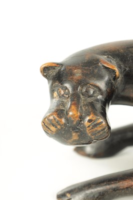 Lot 894 - A 19TH/EARLY 20TH CENTURY CARVED STAINED HARDWOOD SCULPTURE OF A RECUMBENT BIG CAT