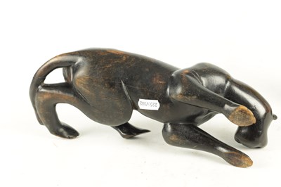 Lot 894 - A 19TH/EARLY 20TH CENTURY CARVED STAINED HARDWOOD SCULPTURE OF A RECUMBENT BIG CAT