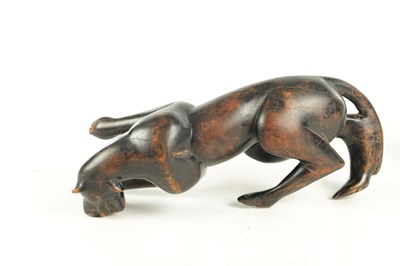 Lot 894 - A 19TH/EARLY 20TH CENTURY CARVED STAINED HARDWOOD SCULPTURE OF A RECUMBENT BIG CAT