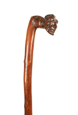 Lot 509 - AN EARLY 19TH CENTURY FOLK ART CARVED WALKING STICK