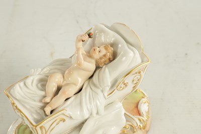 Lot 106 - A 19TH CENTURY MEISSEN CRADLE AND CHERUB FIGURE