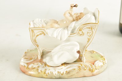 Lot 106 - A 19TH CENTURY MEISSEN CRADLE AND CHERUB FIGURE