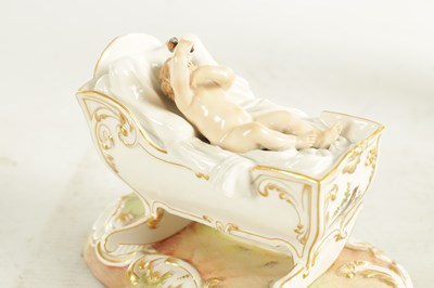 Lot 106 - A 19TH CENTURY MEISSEN CRADLE AND CHERUB FIGURE