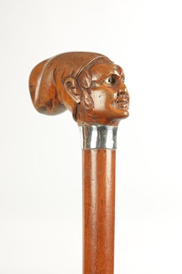 Lot 496 - A COLLECTION OF THREE LATE 19TH CENTURY CARVED WOOD MASK HEAD WALKING STICKS