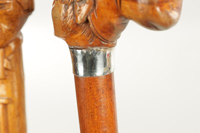 Lot 496 - A COLLECTION OF THREE LATE 19TH CENTURY CARVED WOOD MASK HEAD WALKING STICKS