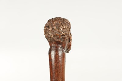 Lot 496 - A COLLECTION OF THREE LATE 19TH CENTURY CARVED WOOD MASK HEAD WALKING STICKS