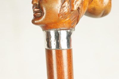 Lot 496 - A COLLECTION OF THREE LATE 19TH CENTURY CARVED WOOD MASK HEAD WALKING STICKS