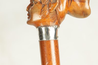 Lot 496 - A COLLECTION OF THREE LATE 19TH CENTURY CARVED WOOD MASK HEAD WALKING STICKS