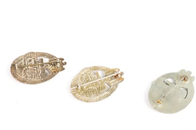 Lot 548 - A COLLECTION OF THREE WW2 GERMAN THIRD REICH SILVER AND SILVER METAL PANZER ASSAULT BADGES