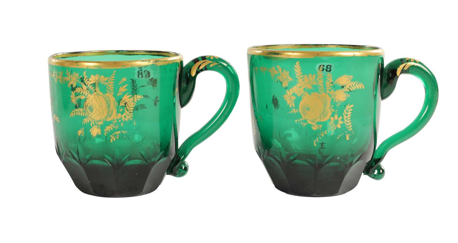 Lot 10 - A PAIR OF LATE GEORGIAN BRISTOL GREEN GLASS CUPS IN THE MANNER OF JAMES GILES