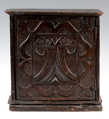 Lot 819 - A 17th CENTURY CARVED OAK SPICE CUPBOARD the...