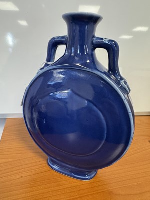 Lot 147 - A 19TH CENTURY BLUE GLAZED CHINESE MOON FLASK