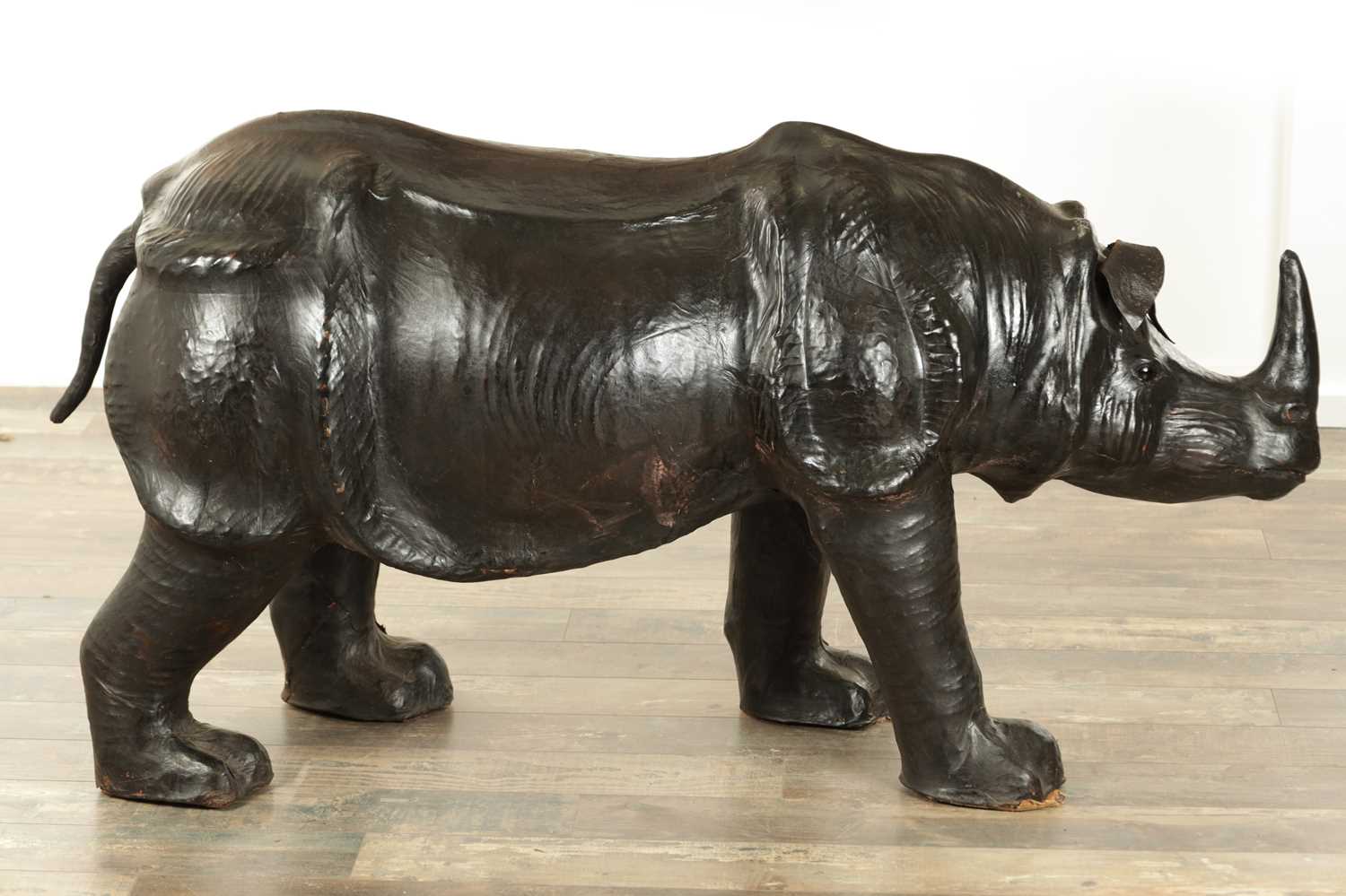 Lot 628 - A LARGE LIBERTY STYLE LEATHER BOUND MODEL OF A RHINO