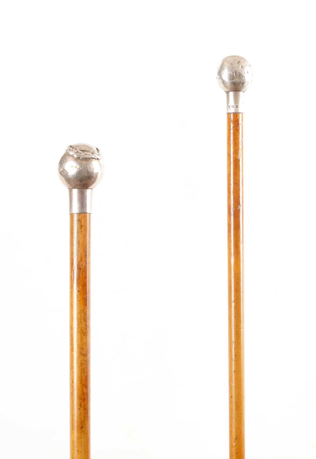 Lot 654 - TWO EARLY 20TH CENTURY SILVER TOPPED MALACCA CANE SWAGGER STICKS