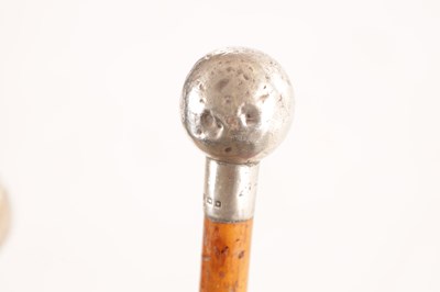 Lot 654 - TWO EARLY 20TH CENTURY SILVER TOPPED MALACCA CANE SWAGGER STICKS