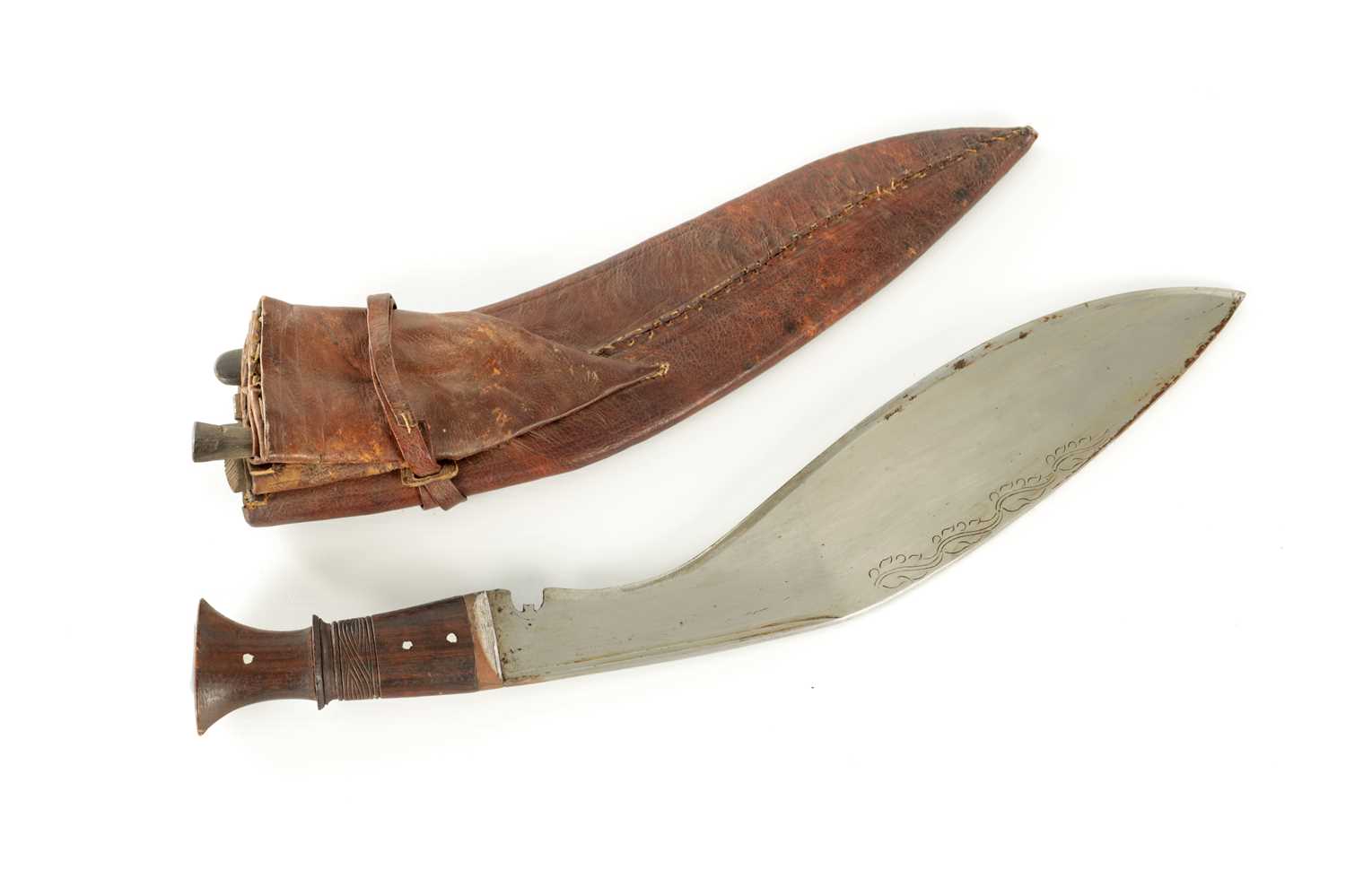 Lot 663 - A 19TH CENTURY NEPALESE MACHETTI WITH LEAF ENGRAVED STEEL BLADE AND RIVETED ROSEWOOD HANDLE