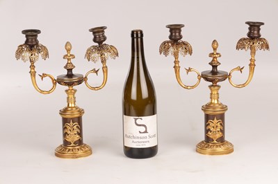 Lot 730 - A PAIR OF REGENCY FRENCH BRONZE AND GILT BRONZE TWO BRANCH CANDELABRA